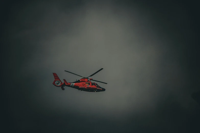 the helicopter is flying through the cloudy skies