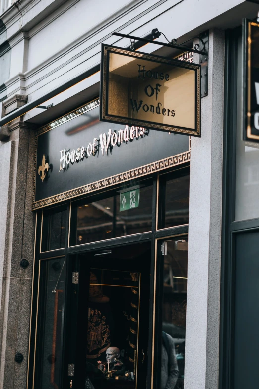 a sign for a woman's hair salon that reads the house of wonders