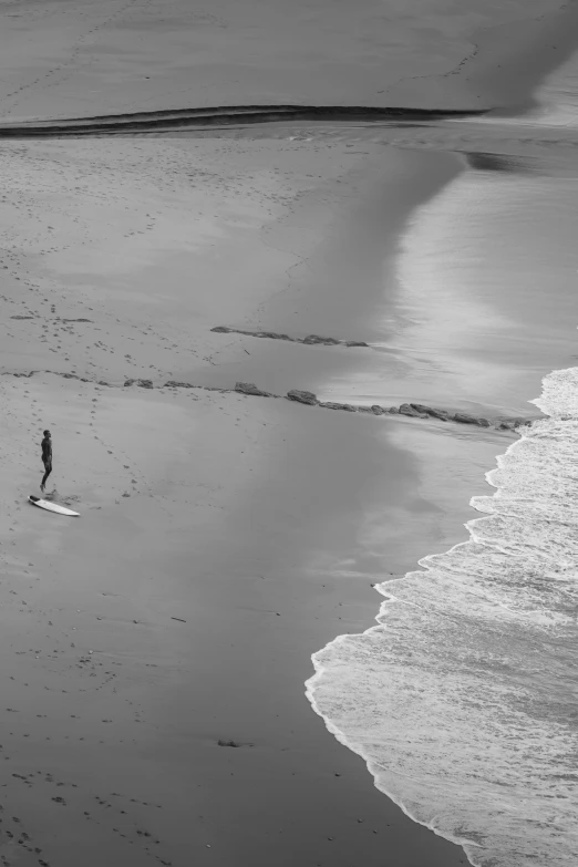 black and white pograph of a lone person on a beach