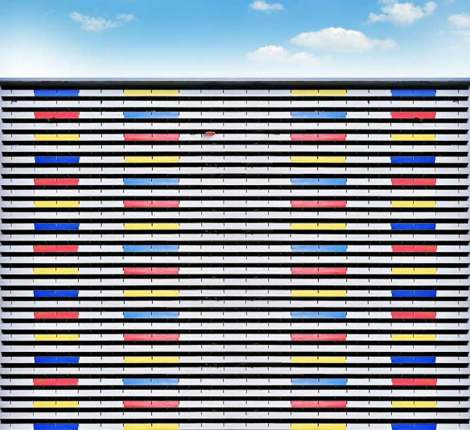 a white building with a sky background, and an array of colorful strips