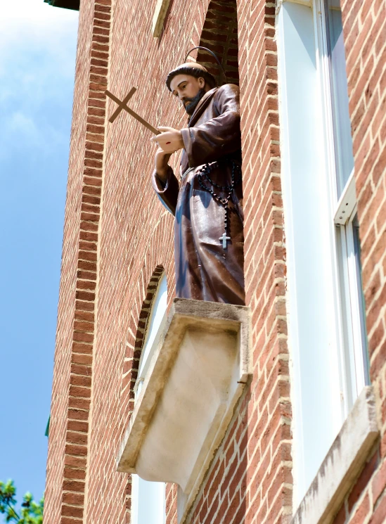 a statue of a man with his arms extended, holding a sword