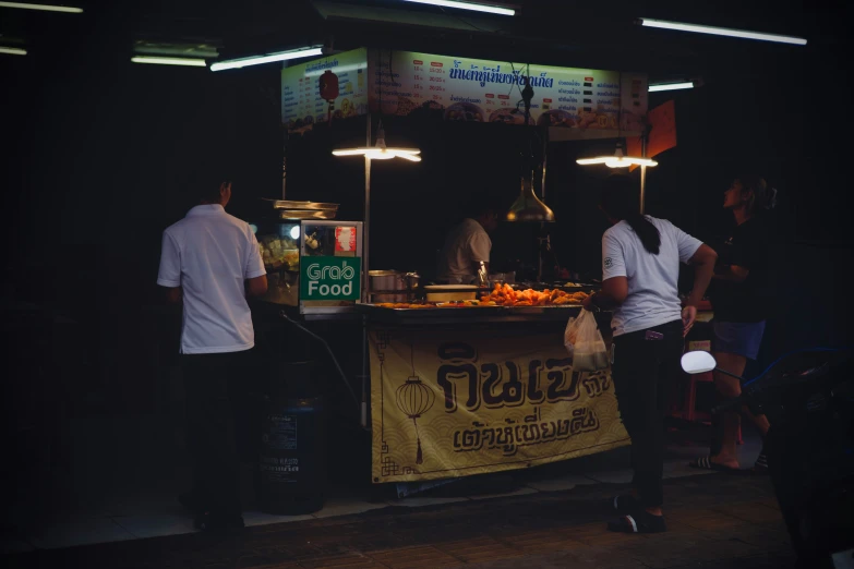 some people are looking at food in the dark