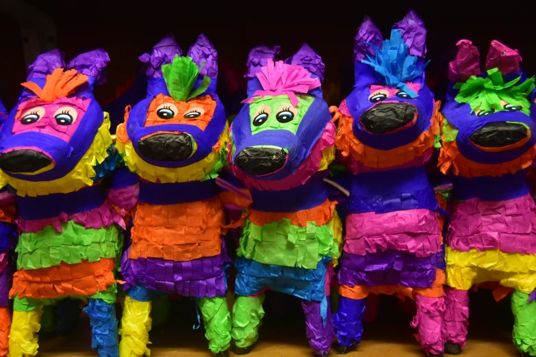 five colorful puppets in brightly colored outfits