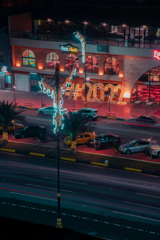 a parking lot with some vehicles and christmas lights