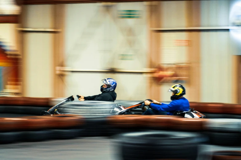 two people are riding on small vehicles