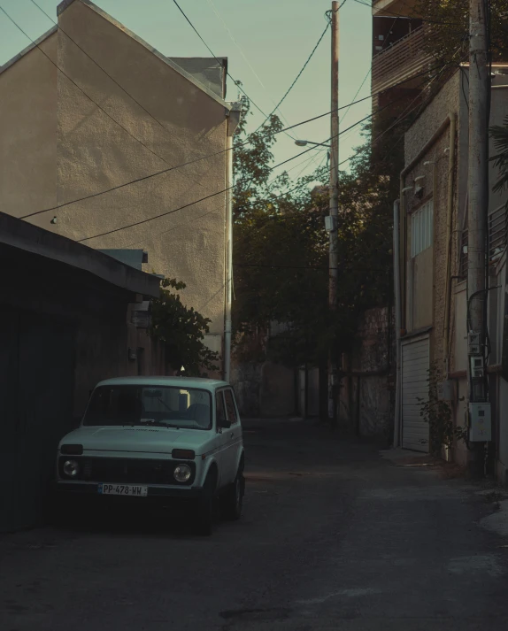 a van is sitting next to the side of an old building