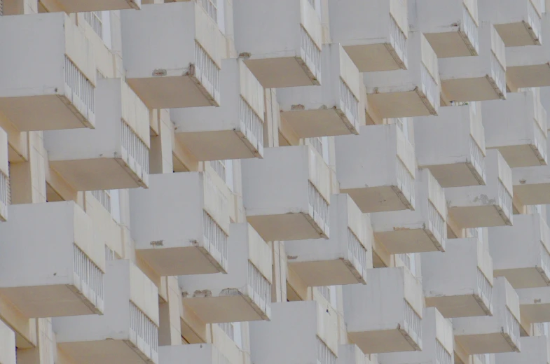 a texture of beige squares on the facade