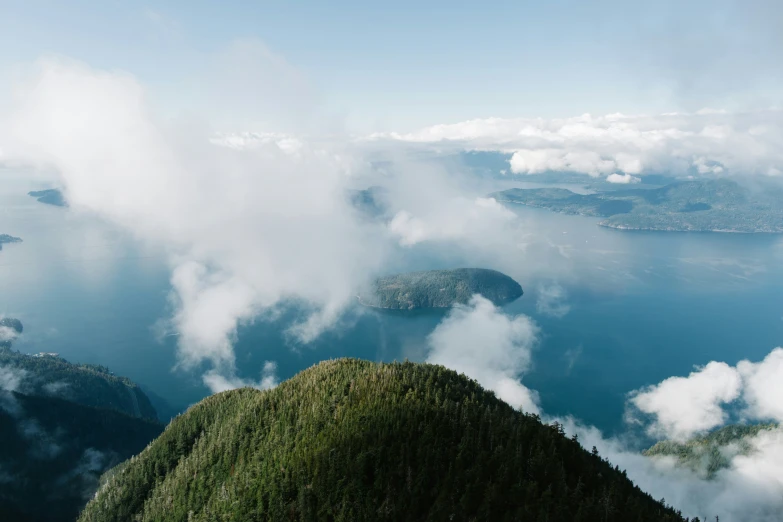 an aerial view of clouds and some mountains