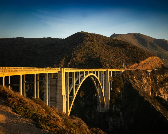 a bridge is shown on a mountain side