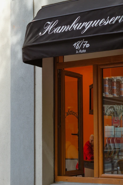 a storefront with a person looking through the window