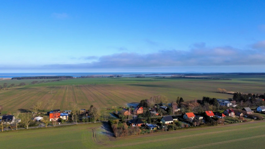 a small island with lots of trees in a large field