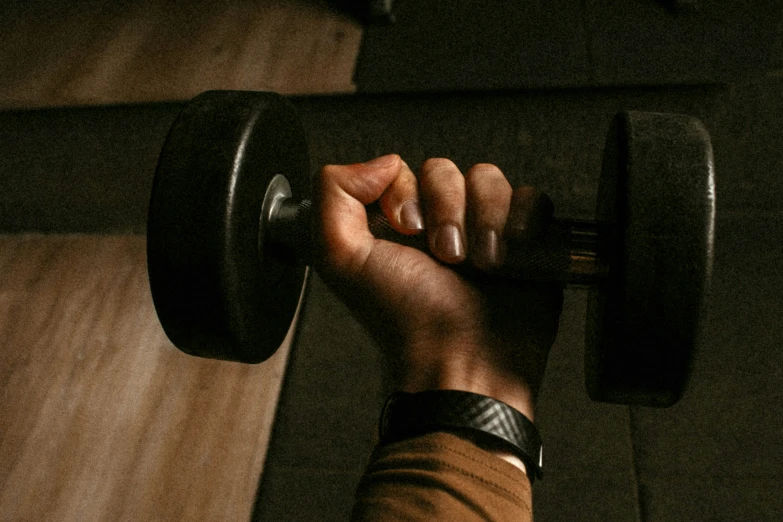 someone lifting a barbell in the dark