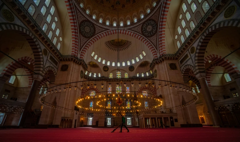 a large building has a big red carpet and tall windows