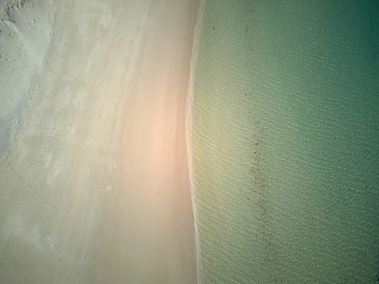 the sun setting on the ocean and beach at an island