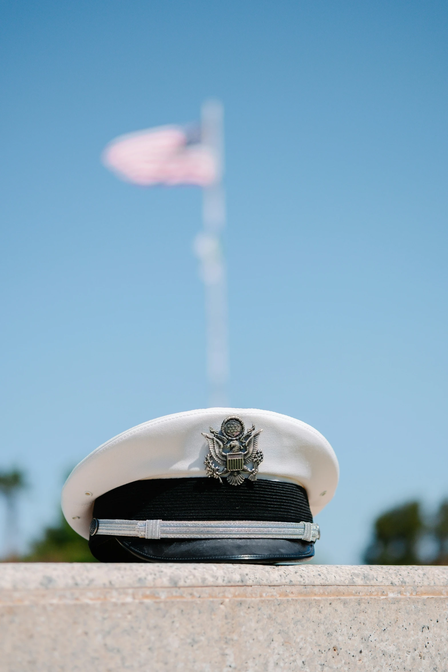 a white hat with a flag in the background