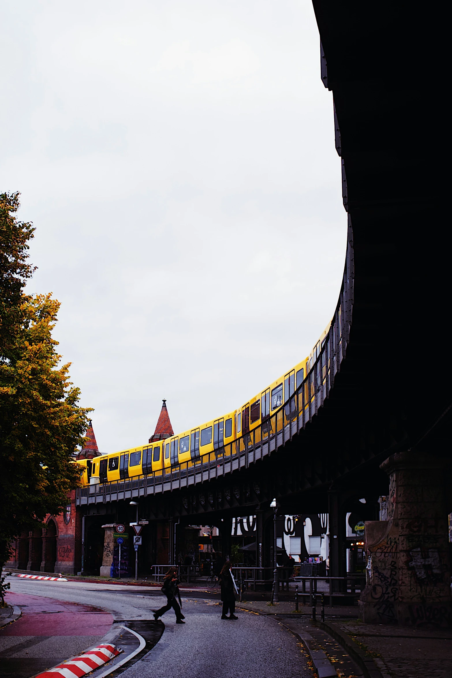 a train riding through a tunnel next to another building