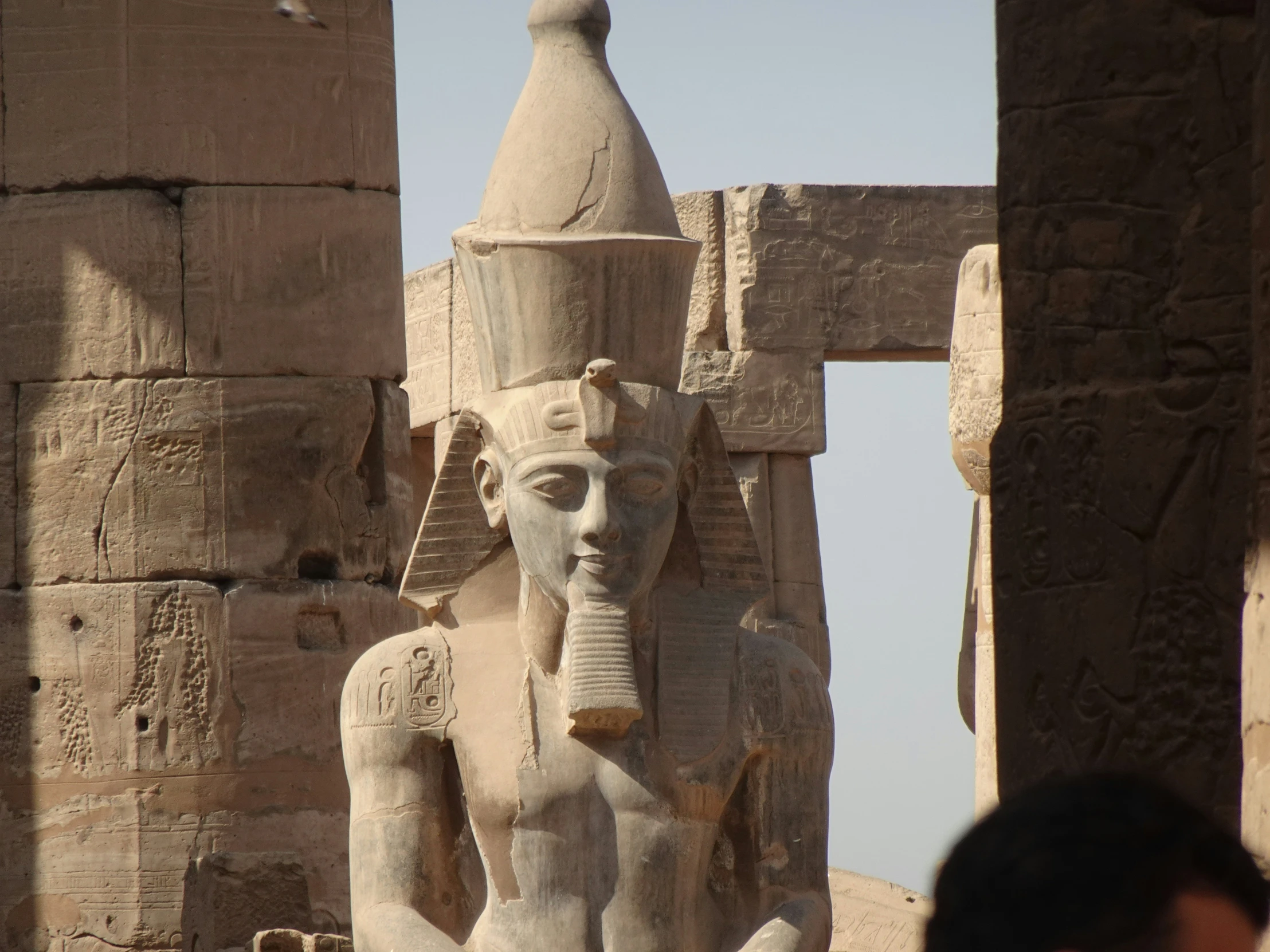a sphinx statue is in front of two buildings