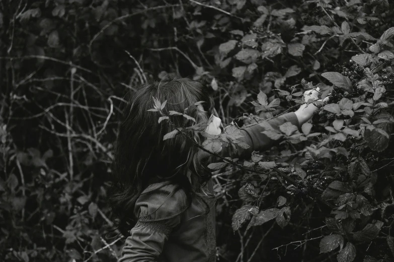 a girl holding onto soing in the woods