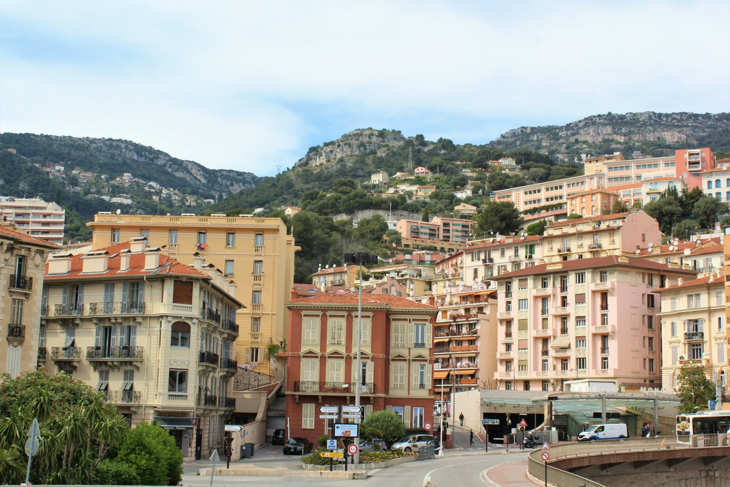 there is a city with mountains behind the buildings