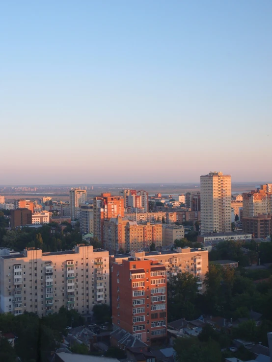 city skyline with a hazy sky as the sun sets