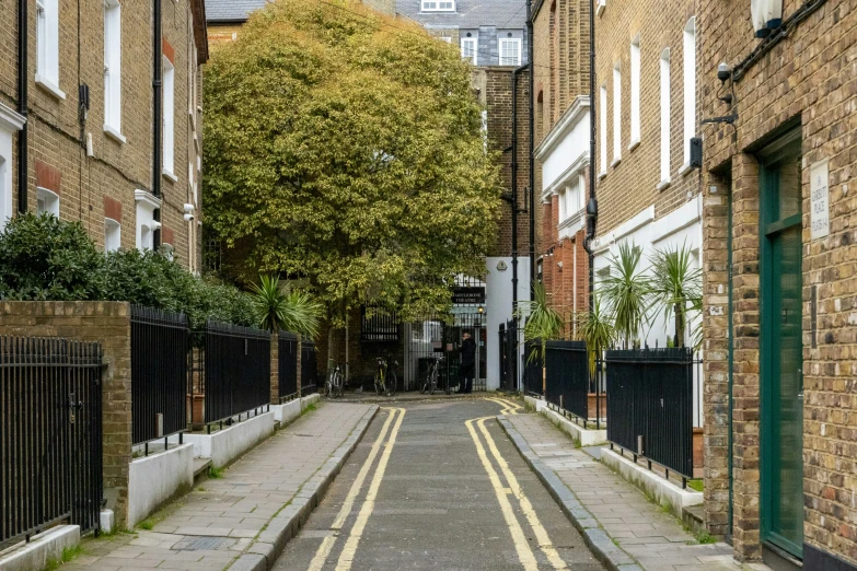 the narrow city street has a yellow line on it