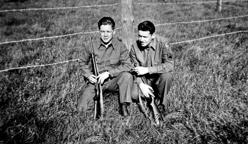 a black and white po of two men in uniform holding sguns