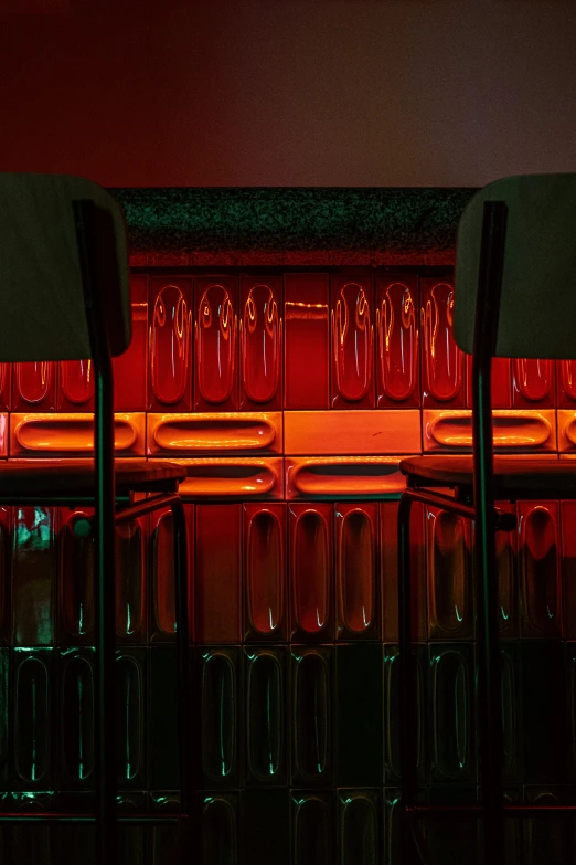 the chairs in front of a wall with red lights