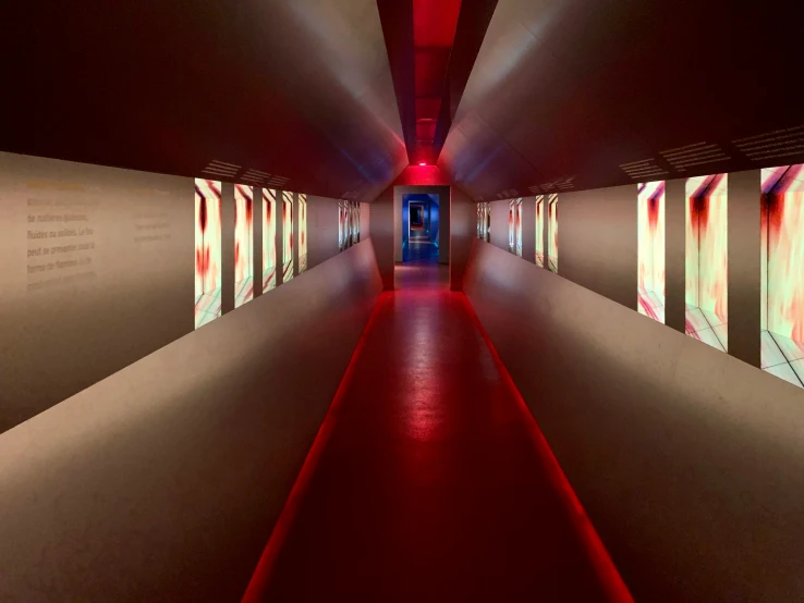 long narrow hallway leading to many red lights