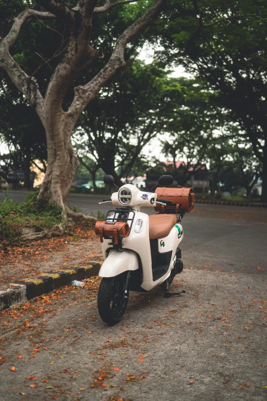 a white and tan motorcycle parked in a parking lot