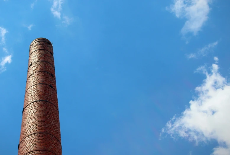 looking up at the side of a brick chimney