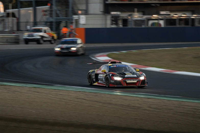 two race cars racing on a track with blurry background