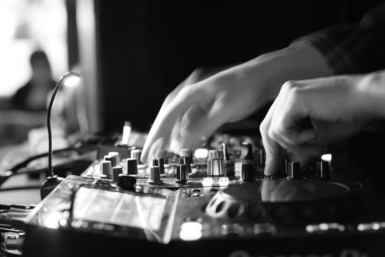 a person mixing music at an indoor venue