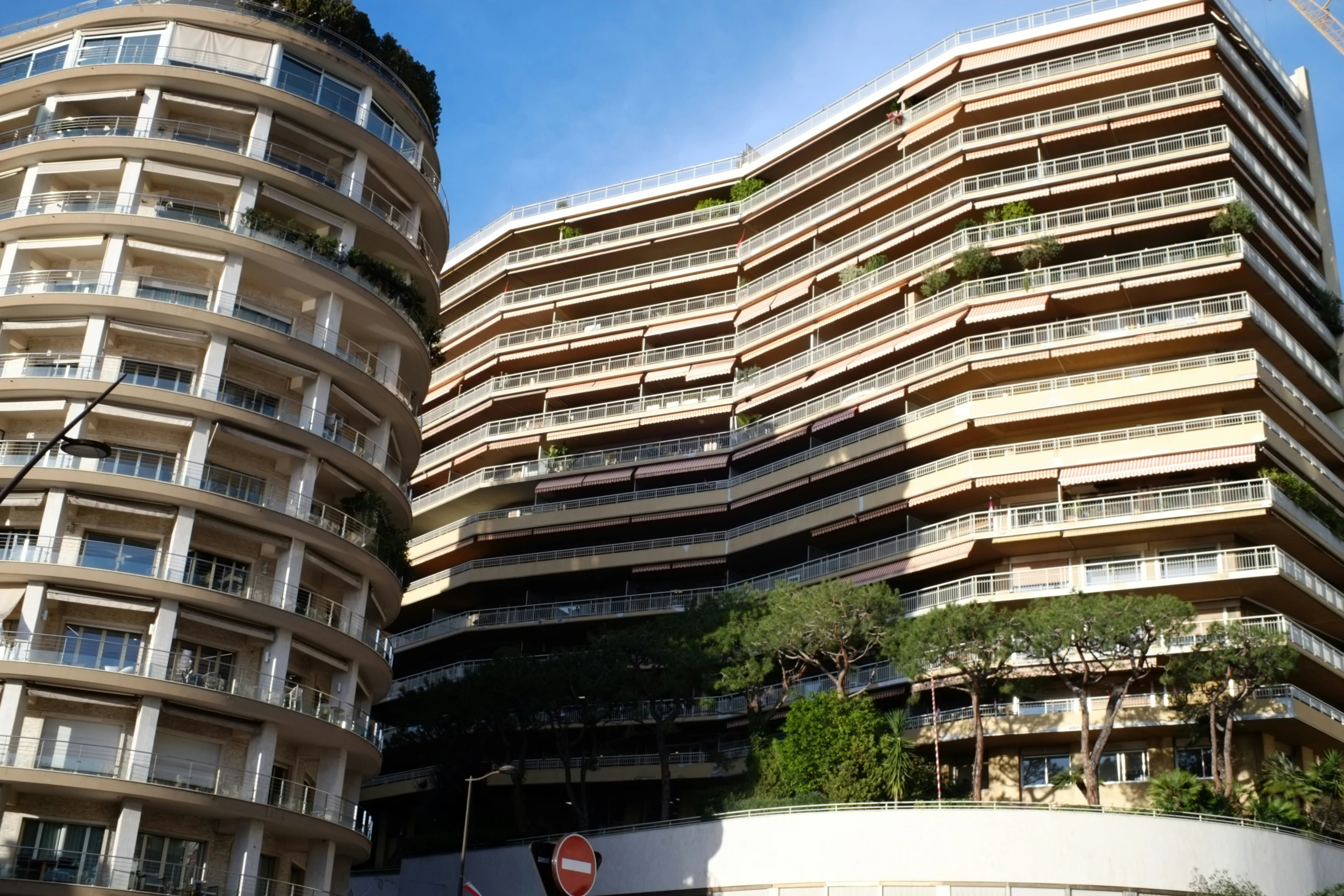 a tall building with green trees growing on the top