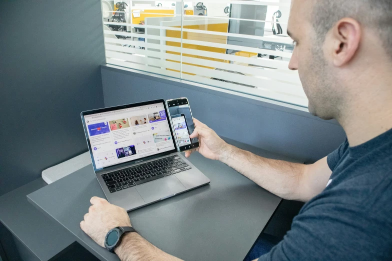 man at laptop displaying the company page displayed on its screen