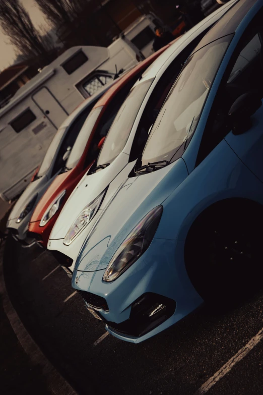 some very pretty colorful cars in a parking lot