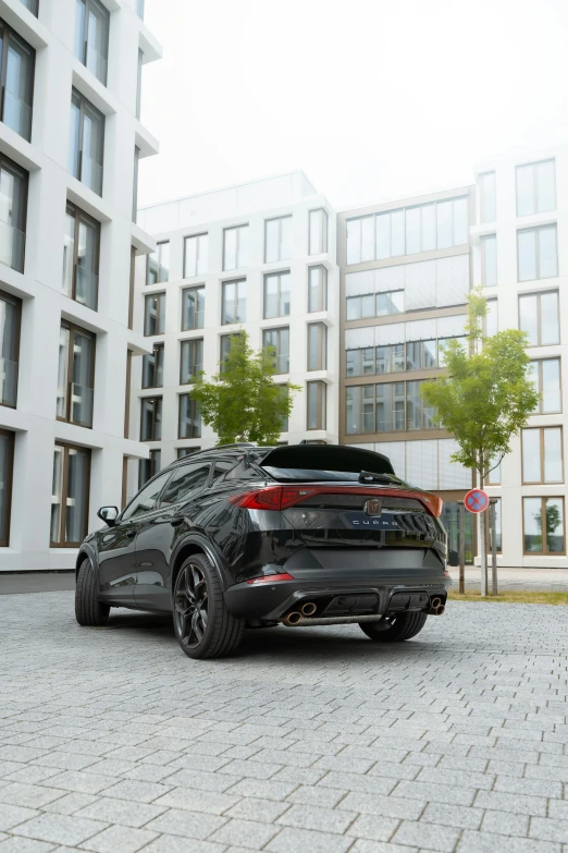 a black sports car parked in a courtyard of a building