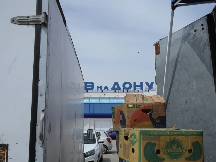 a white truck driving down a street filled with boxes