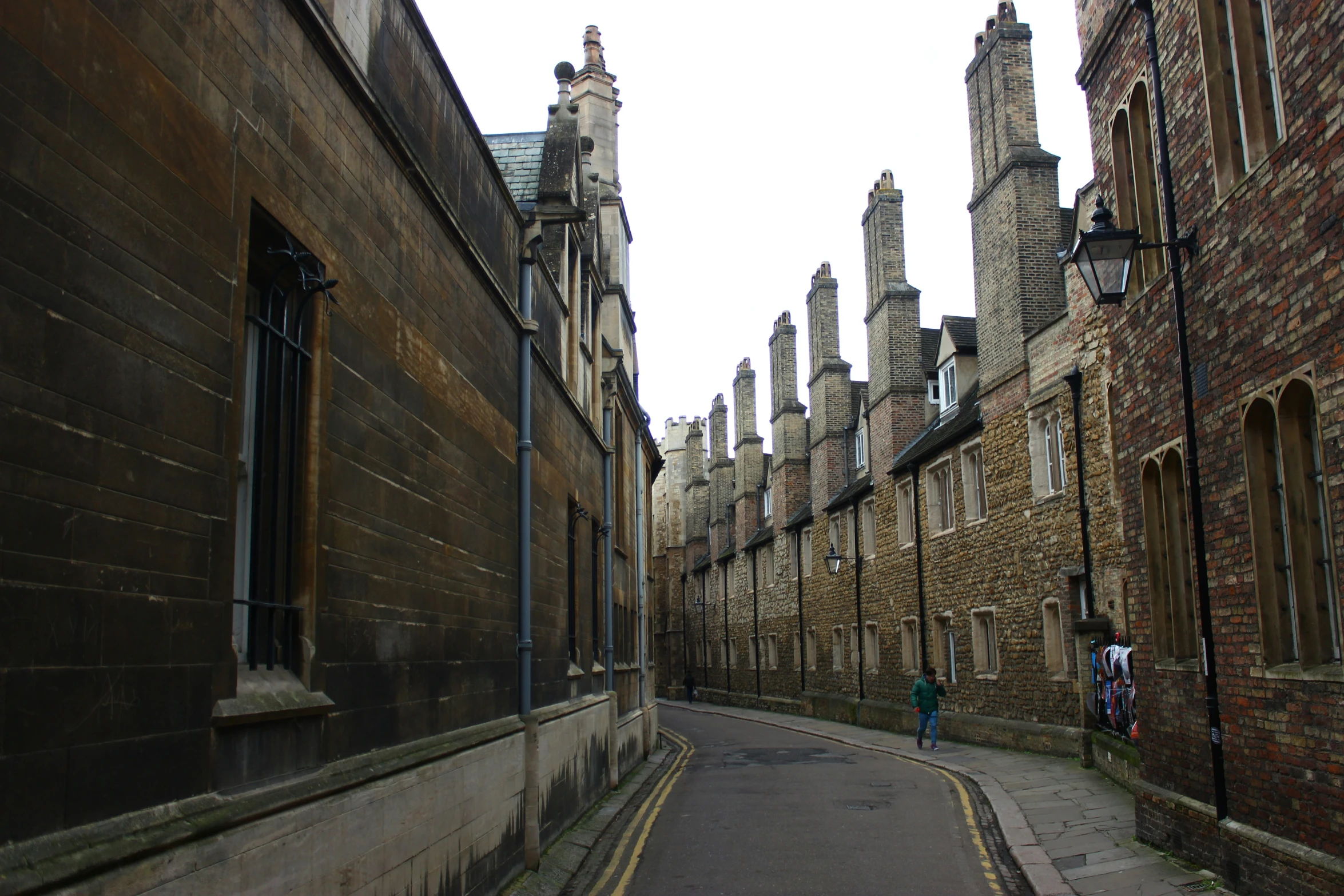 a narrow narrow alley with old brick buildings on either side