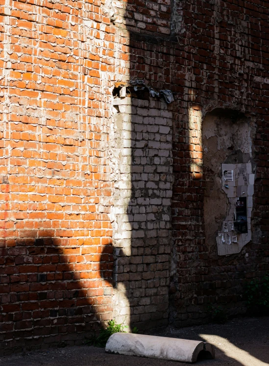 a brick wall and an empty rectangular toilet tube