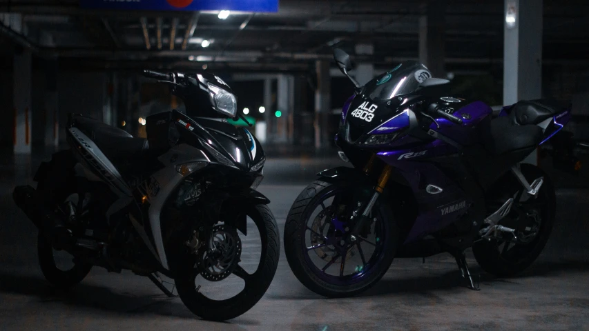 two motorcycles parked in an alley on the side of the road