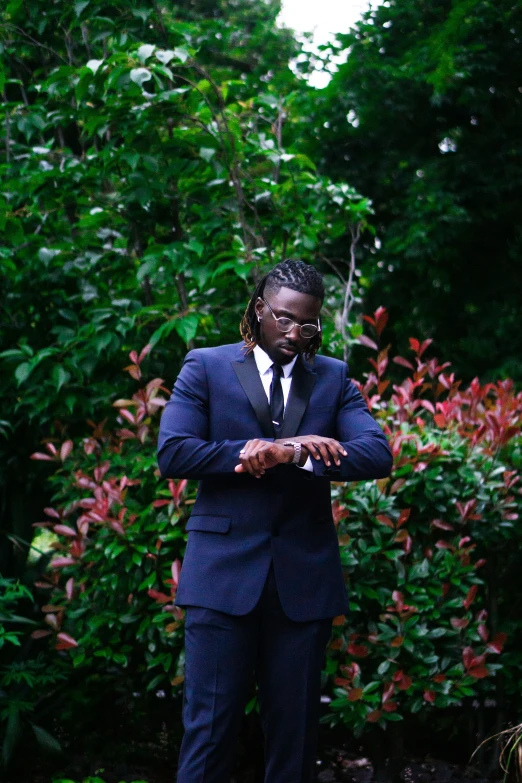 a man is dressed up in a dark suit and sunglasses