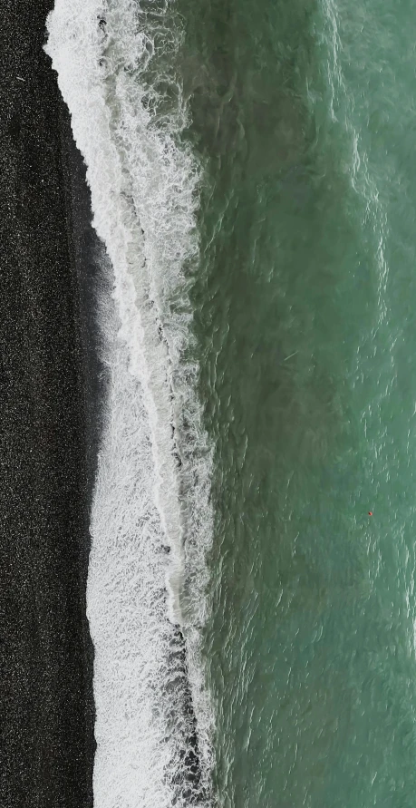 a beach that has waves rolling in and out of the water