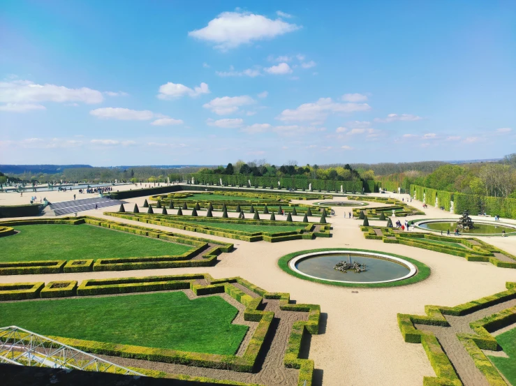 a large lawn surrounded by lots of flowers