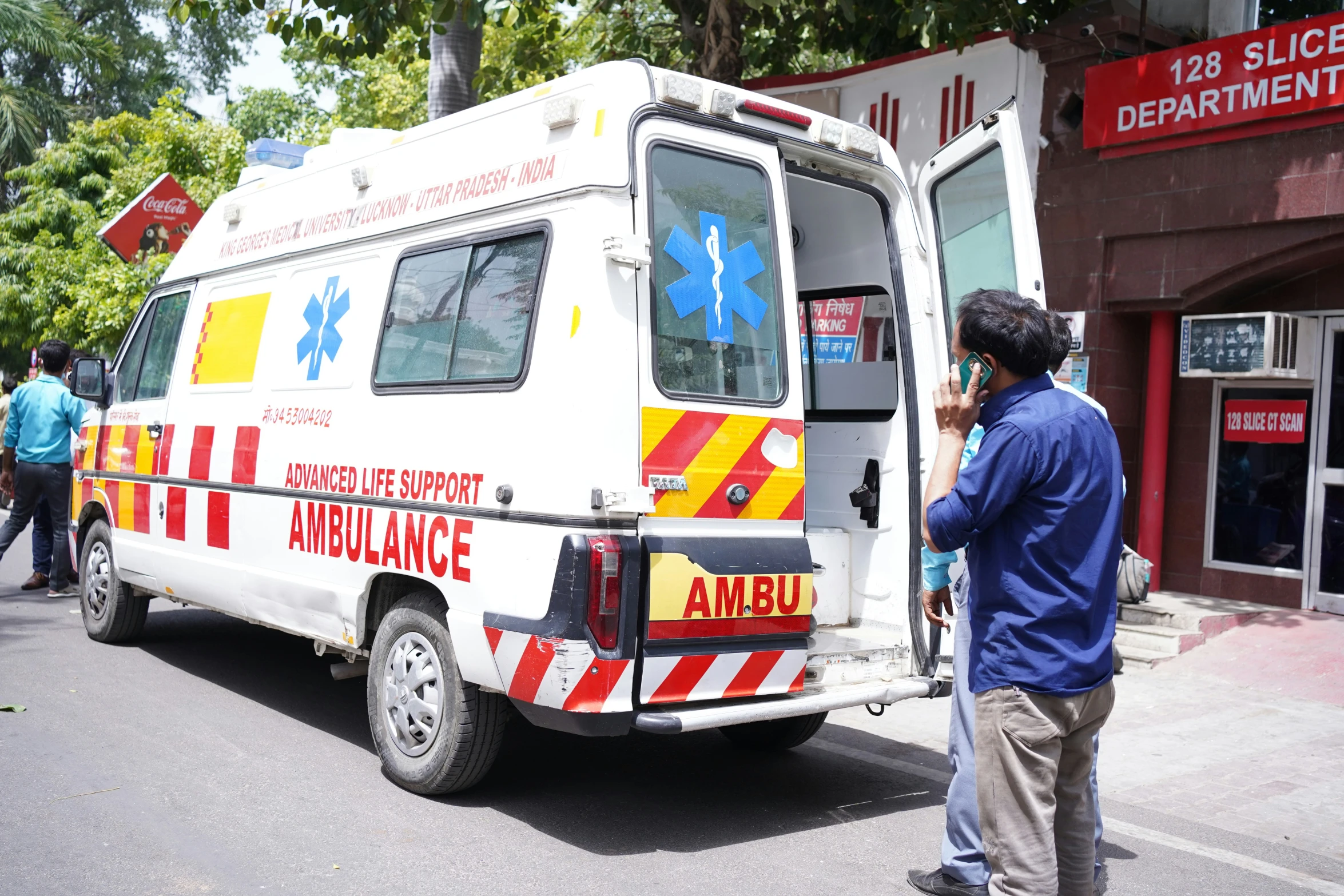 a white ambulance is parked on a street corner