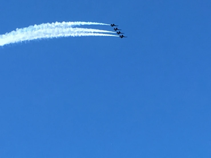two planes are flying upside down, leaving their contrails