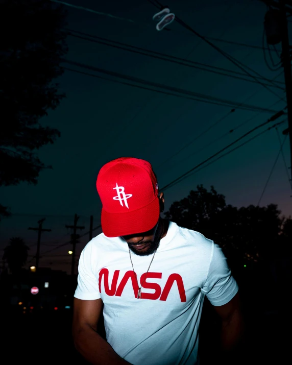 a man in white shirt wearing a red hat