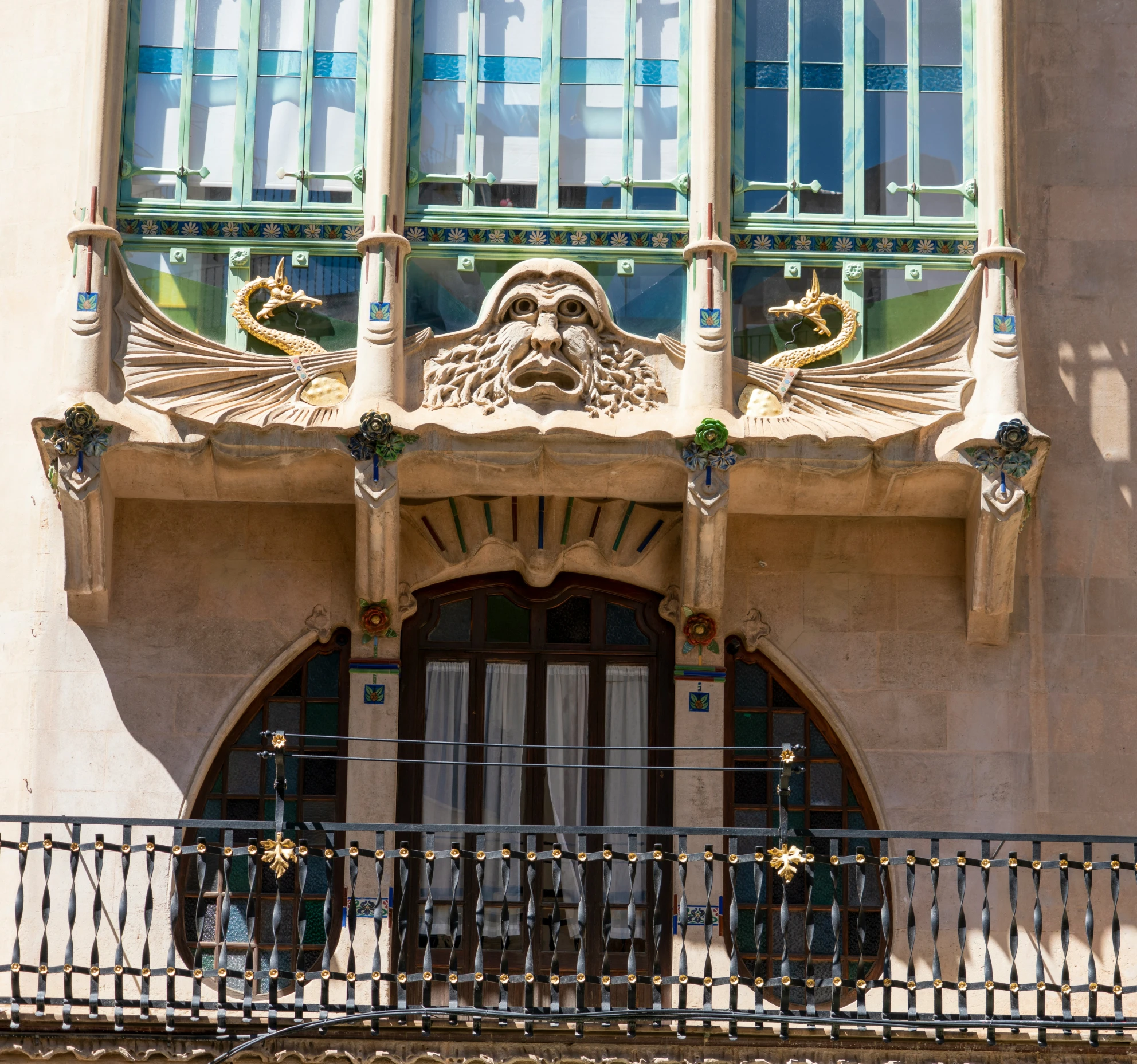 the balcony railings in front of the old fashioned building have decorative ironwork on them