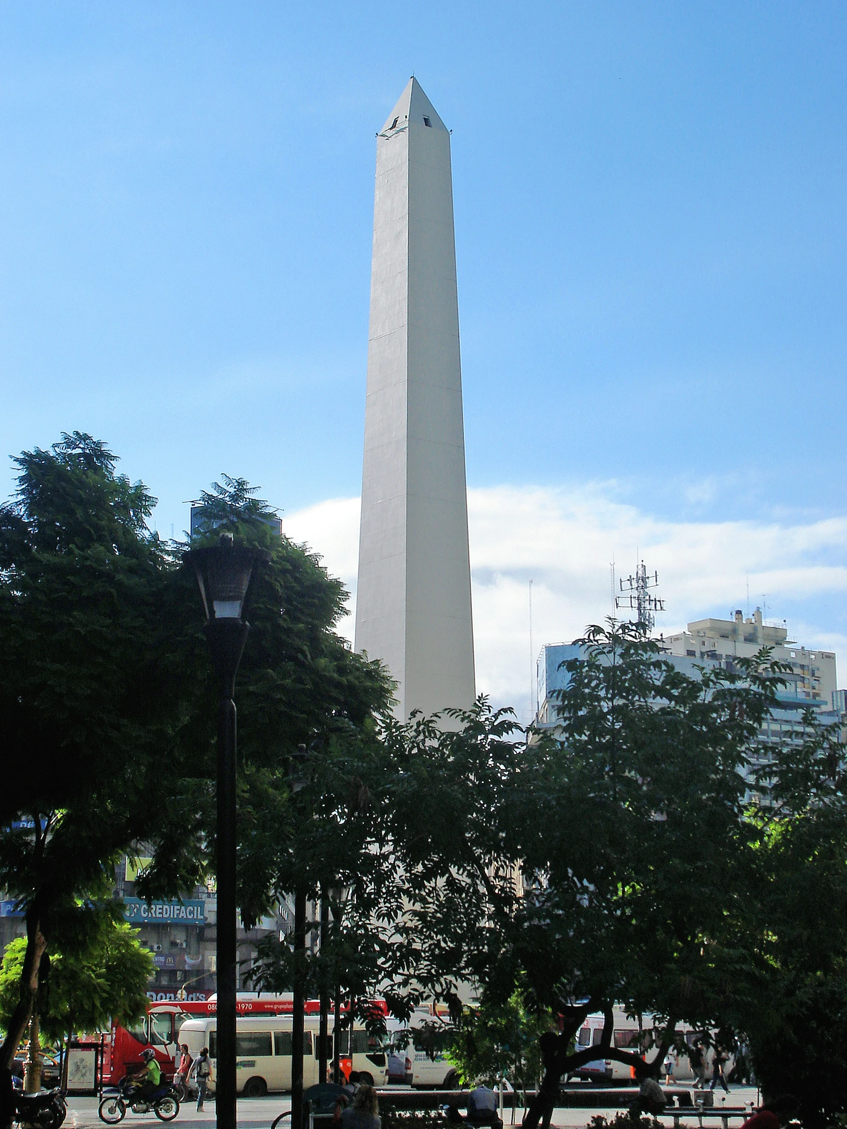 a tall obelisk towering over a city street