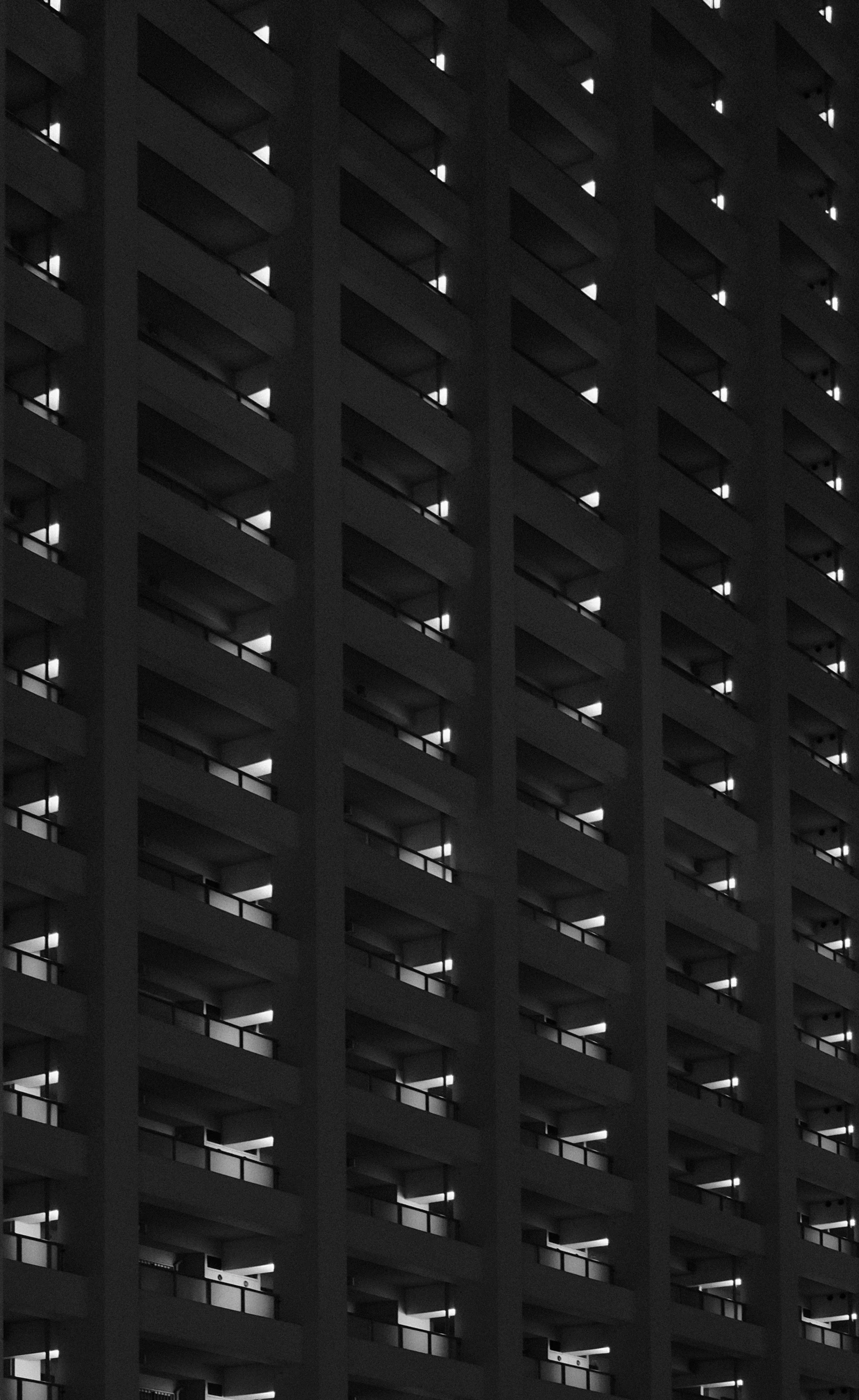 an upward view of a large building at night