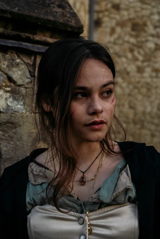 the young woman is standing in front of a building